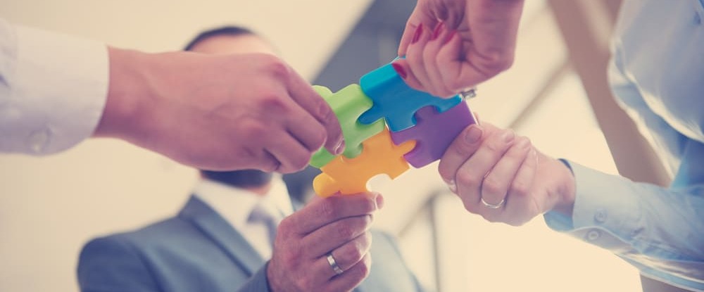 business people group assembling jigsaw puzzle