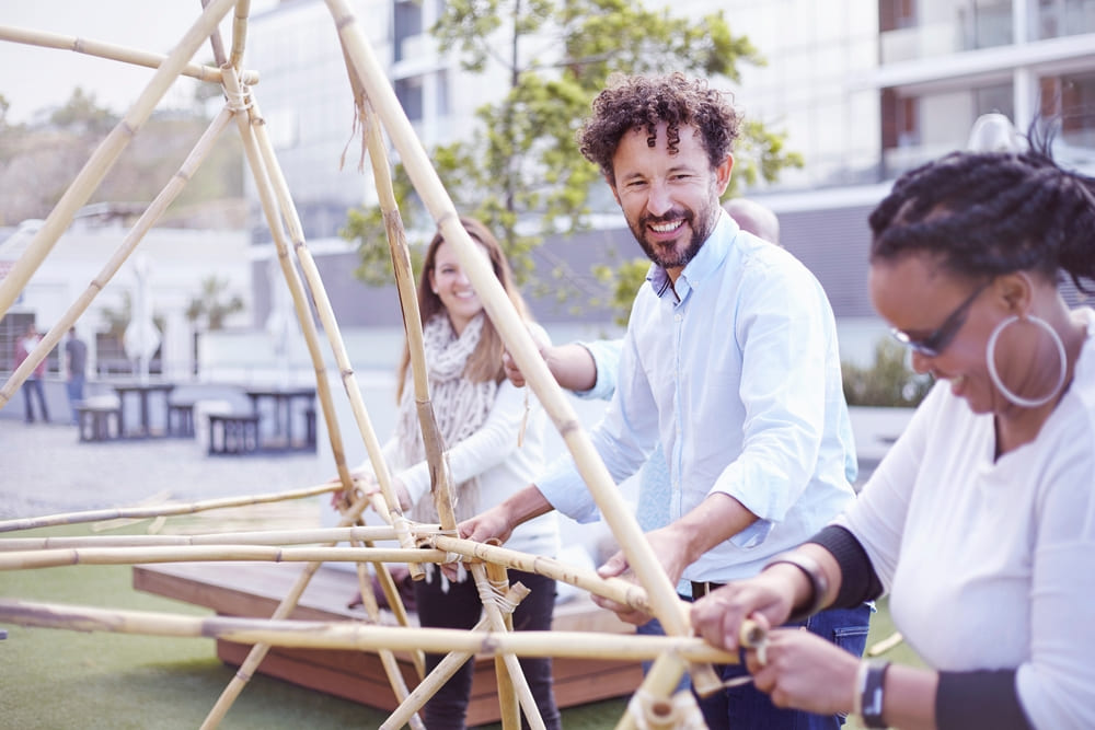 colleagues in team building task building wooden
